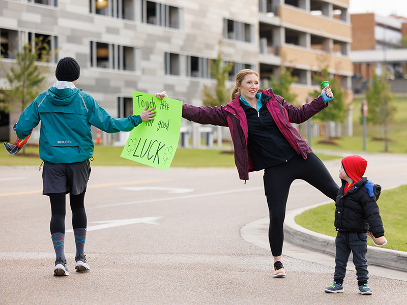 Abbey Phillips of Madison and son Ward share luck with runners.